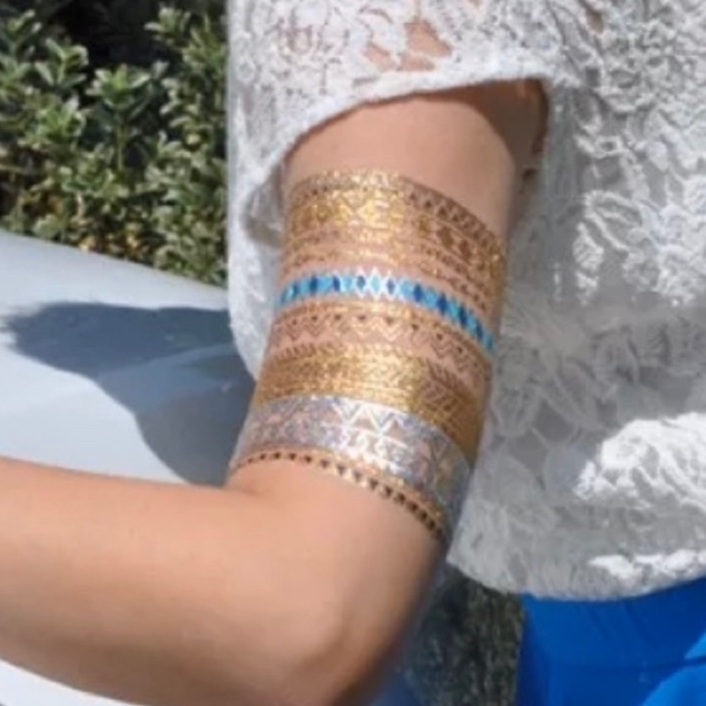 Body tattoos gold, silver and teal